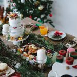 table full of chicken, vegetables and yummy desserts